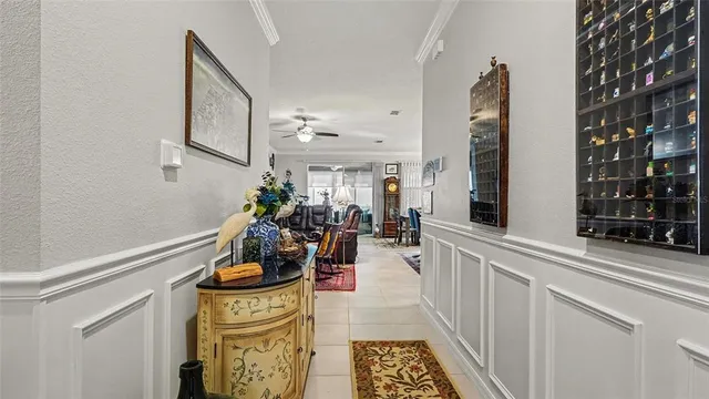 a hallway with a white stove a mirror and cabinets