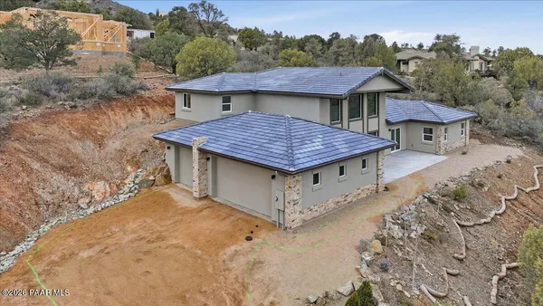 a aerial view of a house with a yard and sitting area