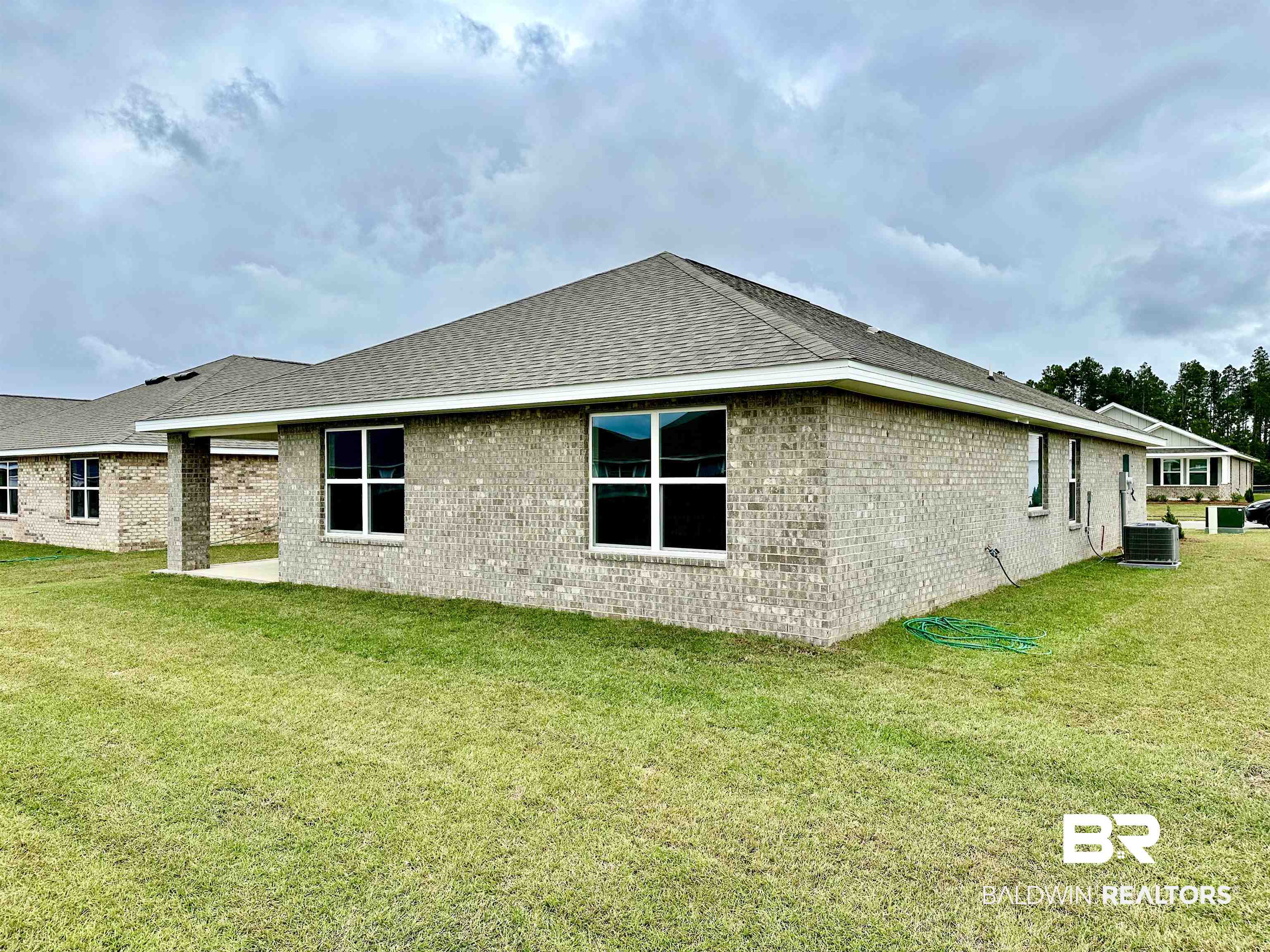 1238 Hayward Loop Foley, AL 36535 - Photo 4 of 46 View of property exterior with central air condition unit and a yard