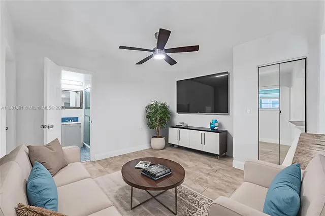 a spacious bedroom with a bed and a large mirror