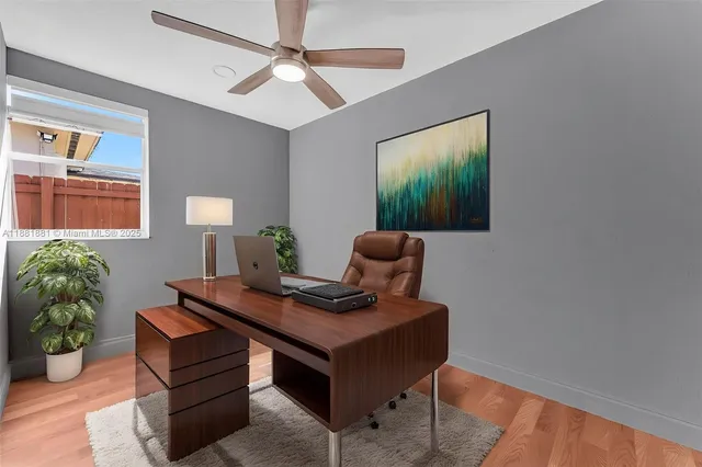 a view of a big room with wooden floor and a ceiling fan