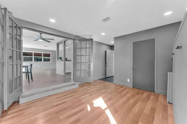 a bedroom with bed and wooden floor