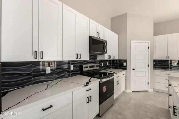 a kitchen with stainless steel appliances a stove a microwave and a sink