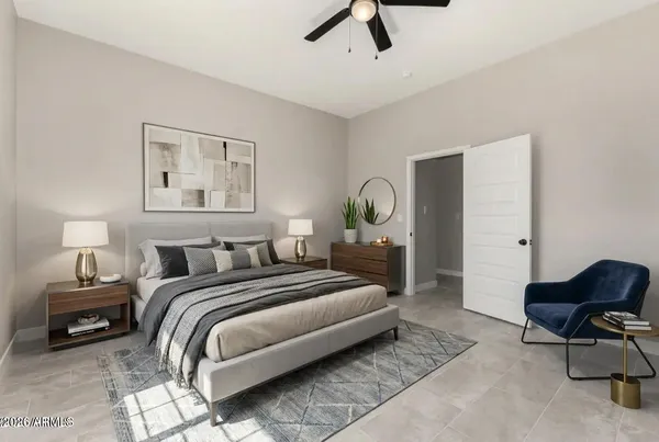 a bedroom with a bed a couch and a potted plant