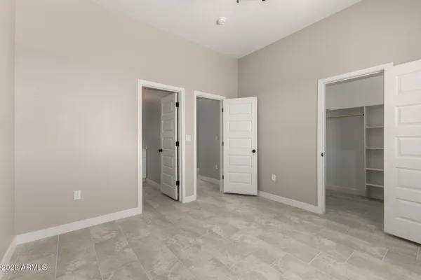 an empty room with closet and a bathroom