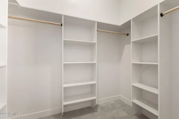 a view of walk in closet with empty racks
