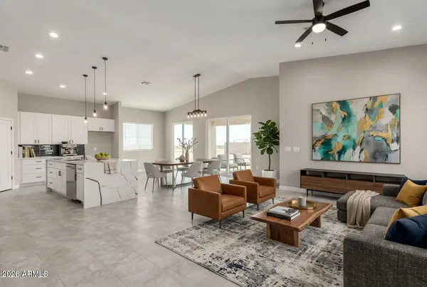 a living room with furniture kitchen and a chandelier