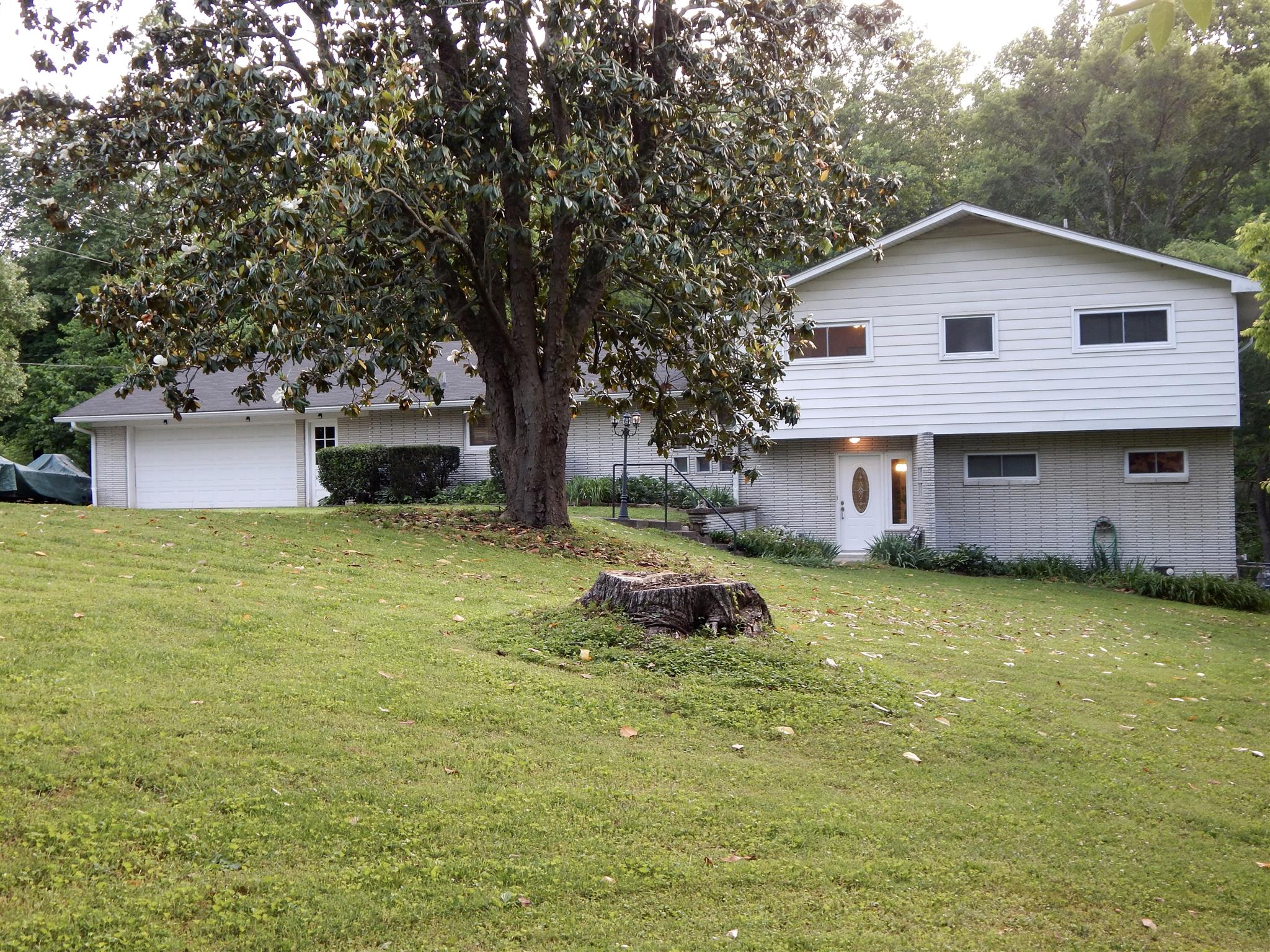 3617 Academy Road Portland, TN 37148 - Photo 1 of 27 a front view of a house with garden