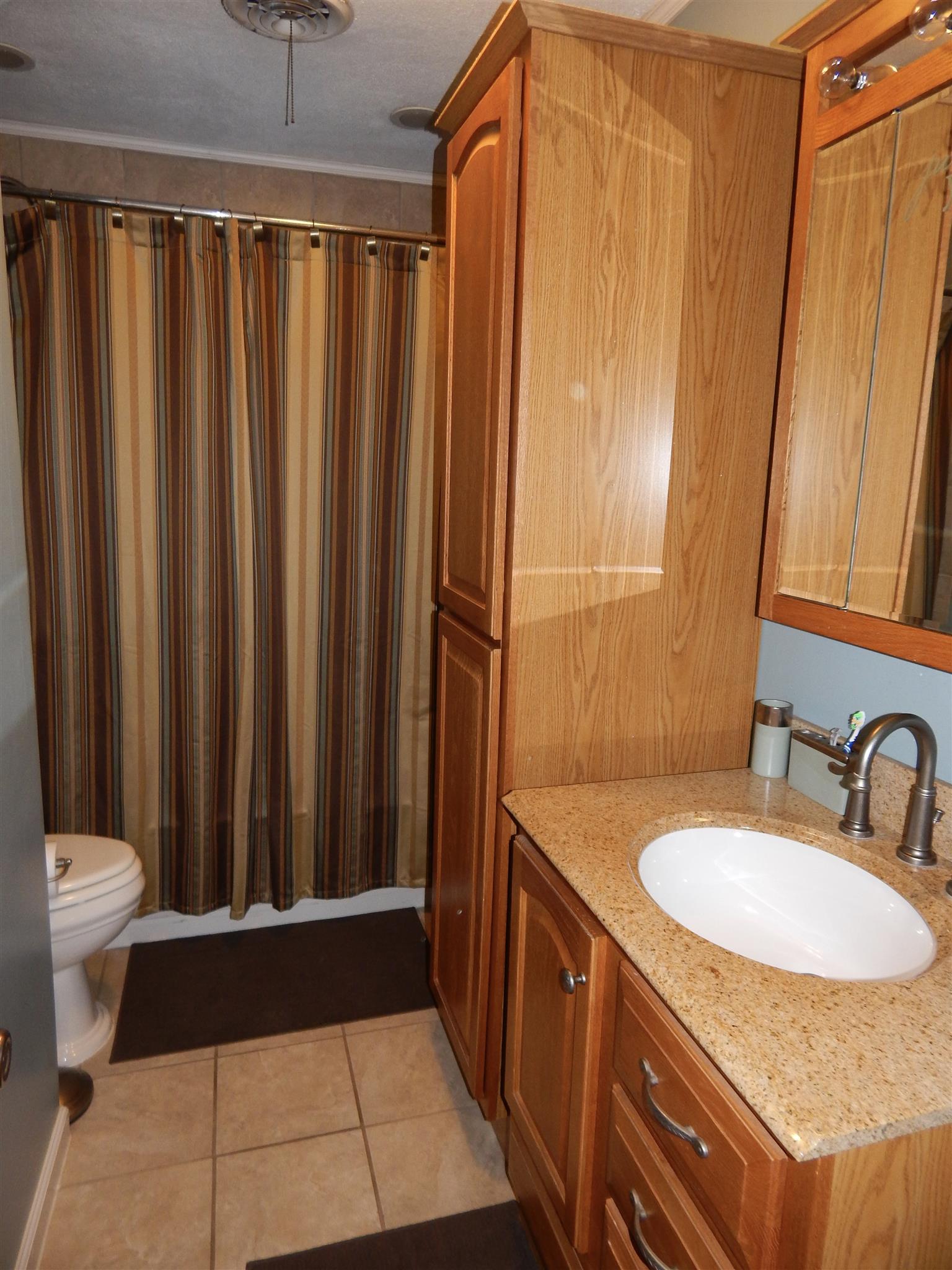 3617 Academy Road Portland, TN 37148 - Photo 20 of 27 a bathroom with a sink and a mirror