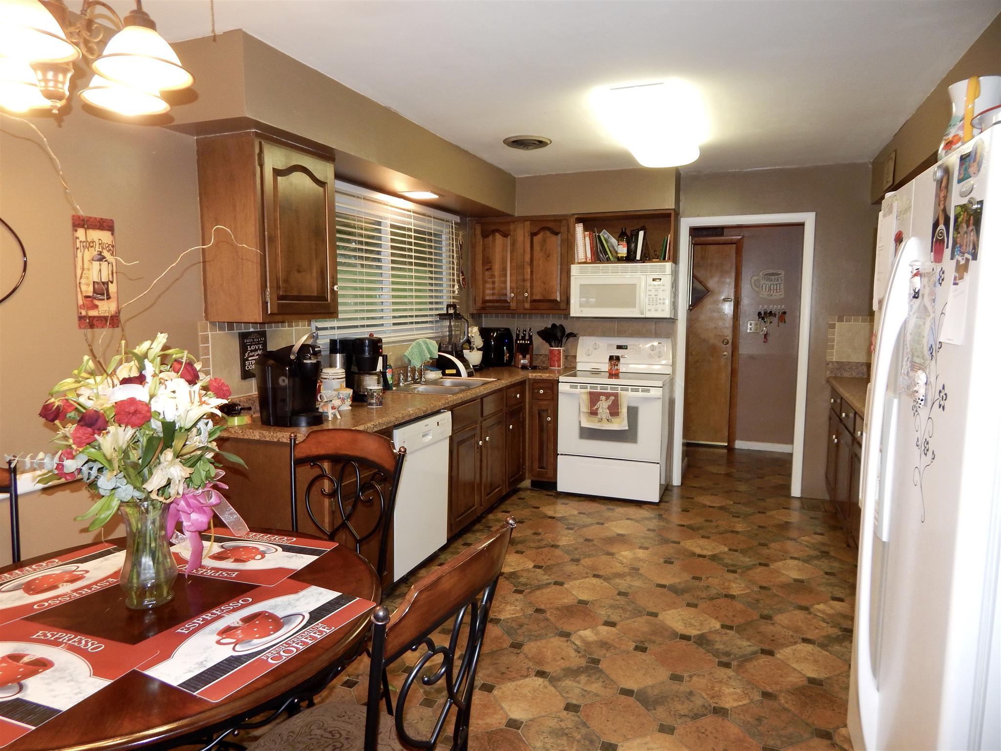 3617 Academy Road Portland, TN 37148 - Photo 6 of 27 a kitchen with stainless steel appliances granite countertop a sink stove and refrigerator