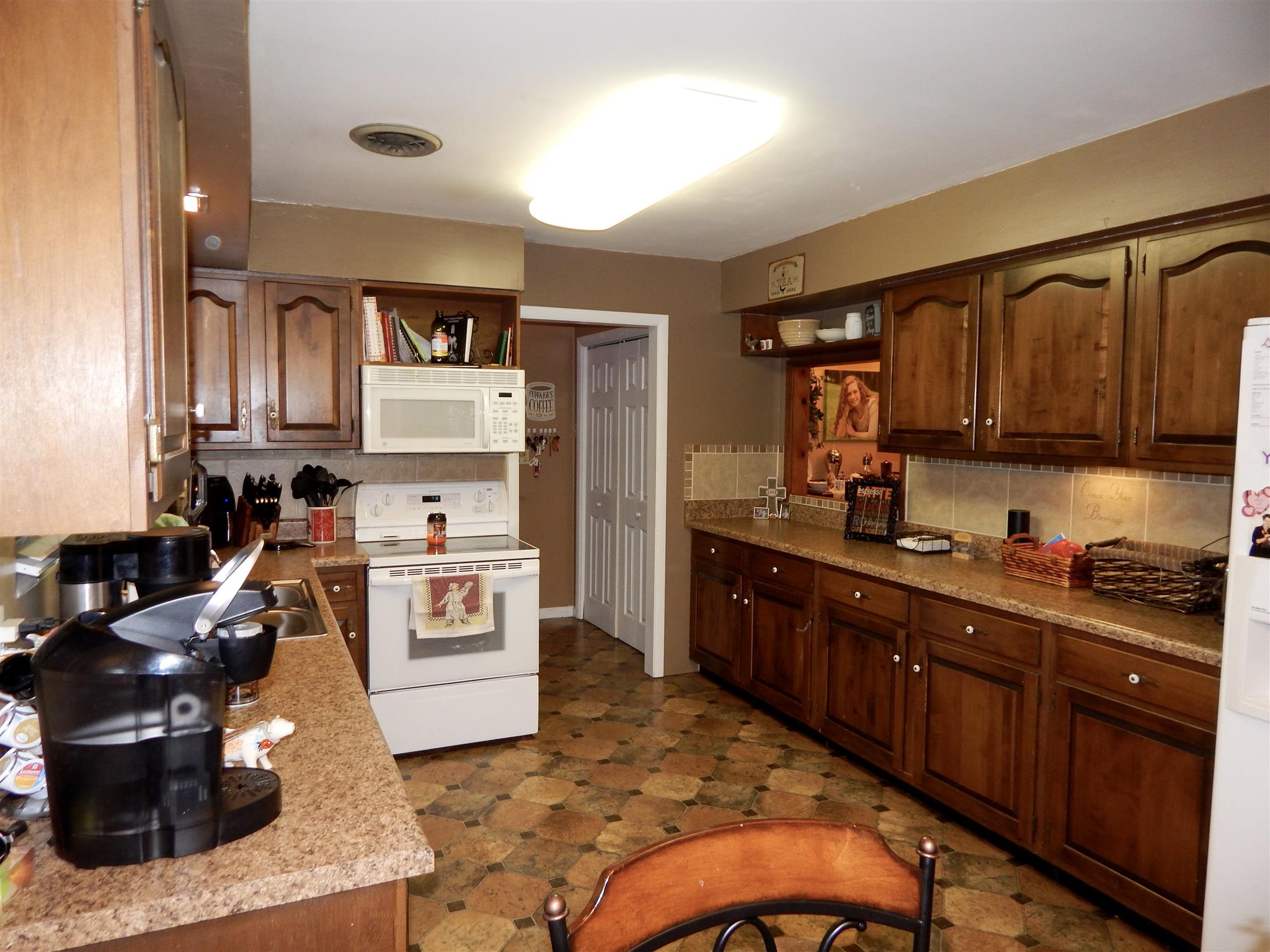 3617 Academy Road Portland, TN 37148 - Photo 7 of 27 a kitchen with stainless steel appliances granite countertop a stove top oven a sink dishwasher and cabinets with wooden floor