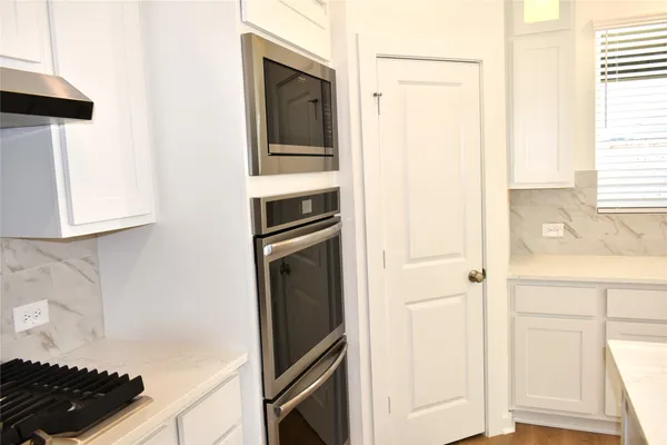 a kitchen with a refrigerator and a stove