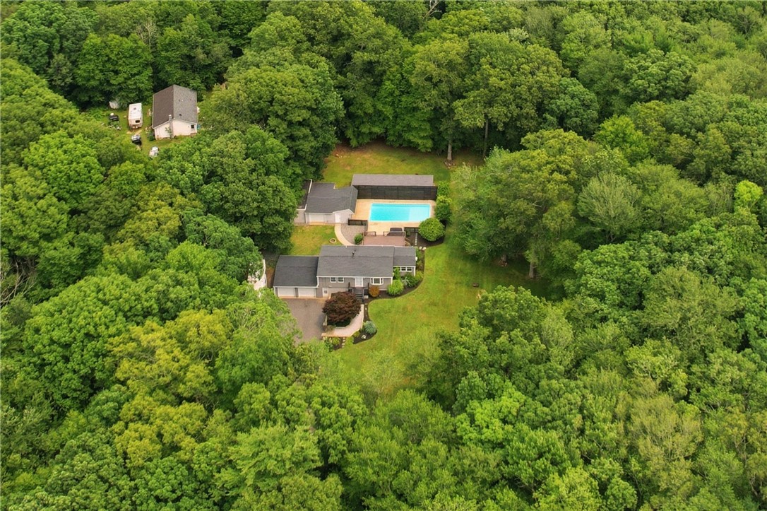 214 Anan Wade Road Glocester, RI 02857 - Photo 4 of 50 Surrounded by a sea of green, the home enjoys a peaceful wooded setting with expansive usable lawn and multiple outdoor living areas.