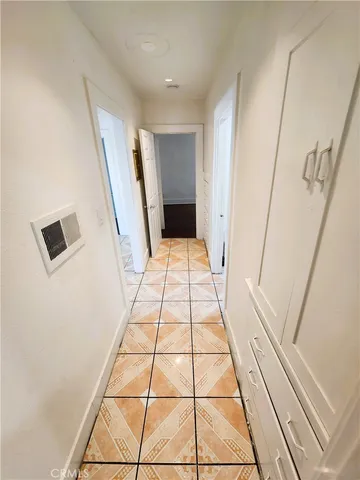 a view of a hallway with wooden floor and white doors