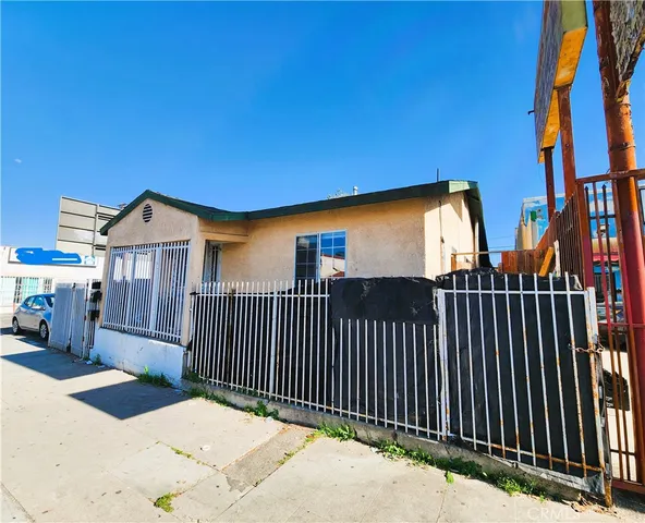 a view of a house with wooden fence