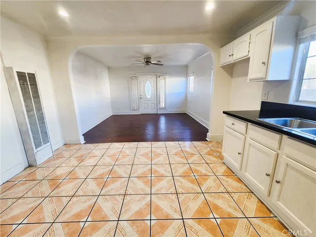 a view of a hallway to rooms and wooden floor