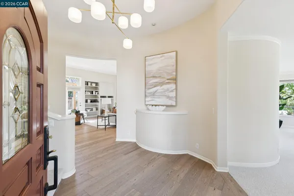 a dining room with furniture window and wooden floor
