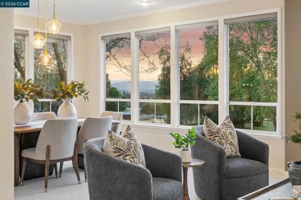 a living room with furniture fireplace and a table
