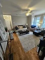 a living room with furniture and a chandelier