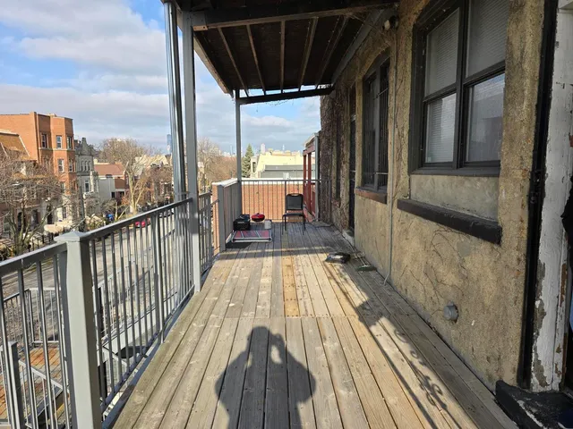 a view of balcony with a glass door and wooden floor