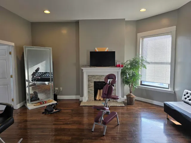 a living room with furniture a fireplace and a flat screen tv