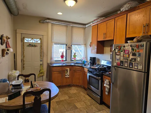 a kitchen with stainless steel appliances granite countertop a sink stove and refrigerator