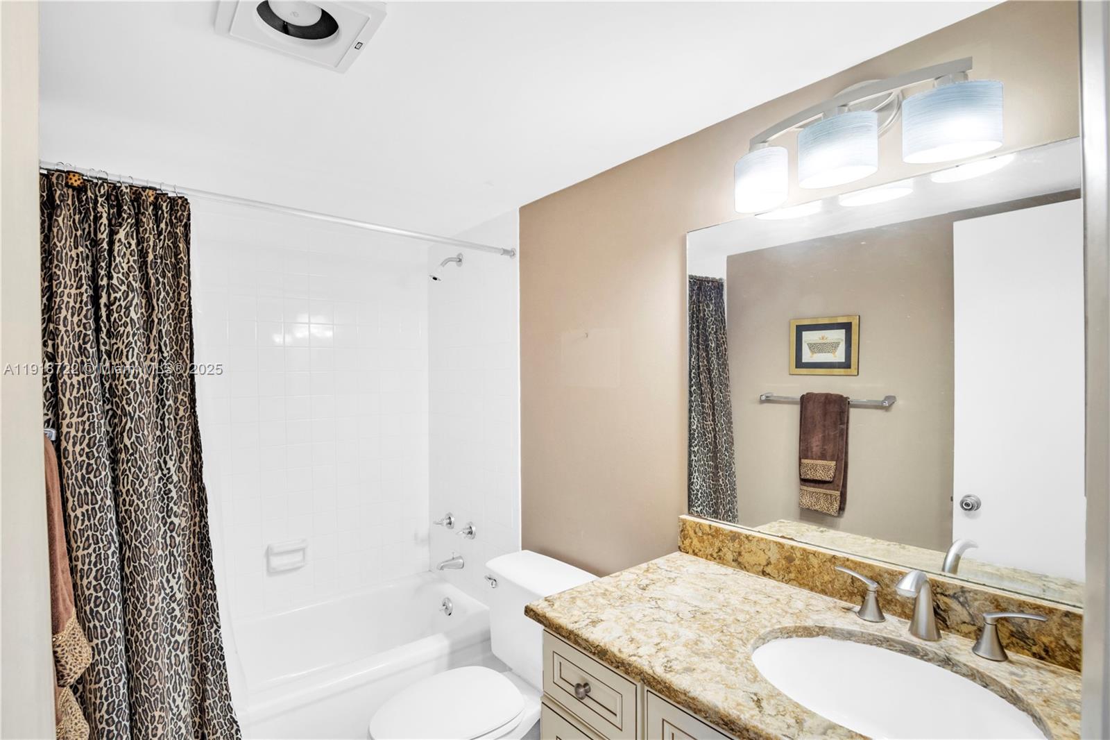 200 Ocean Trail Way, Unit 609 Jupiter, FL 33477 - Photo 16 of 27 a bathroom with a granite countertop sink a toilet a shower and a mirror