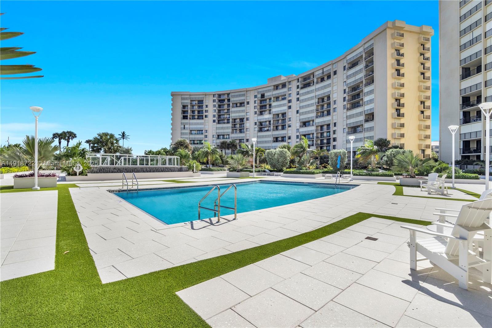 200 Ocean Trail Way, Unit 609 Jupiter, FL 33477 - Photo 4 of 27 a view of a swimming pool with a lawn chairs