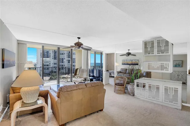 a living room with furniture ceiling fan and a window