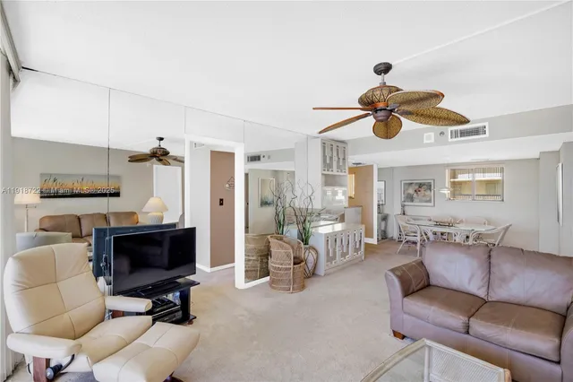 a kitchen with furniture a refrigerator and a stove