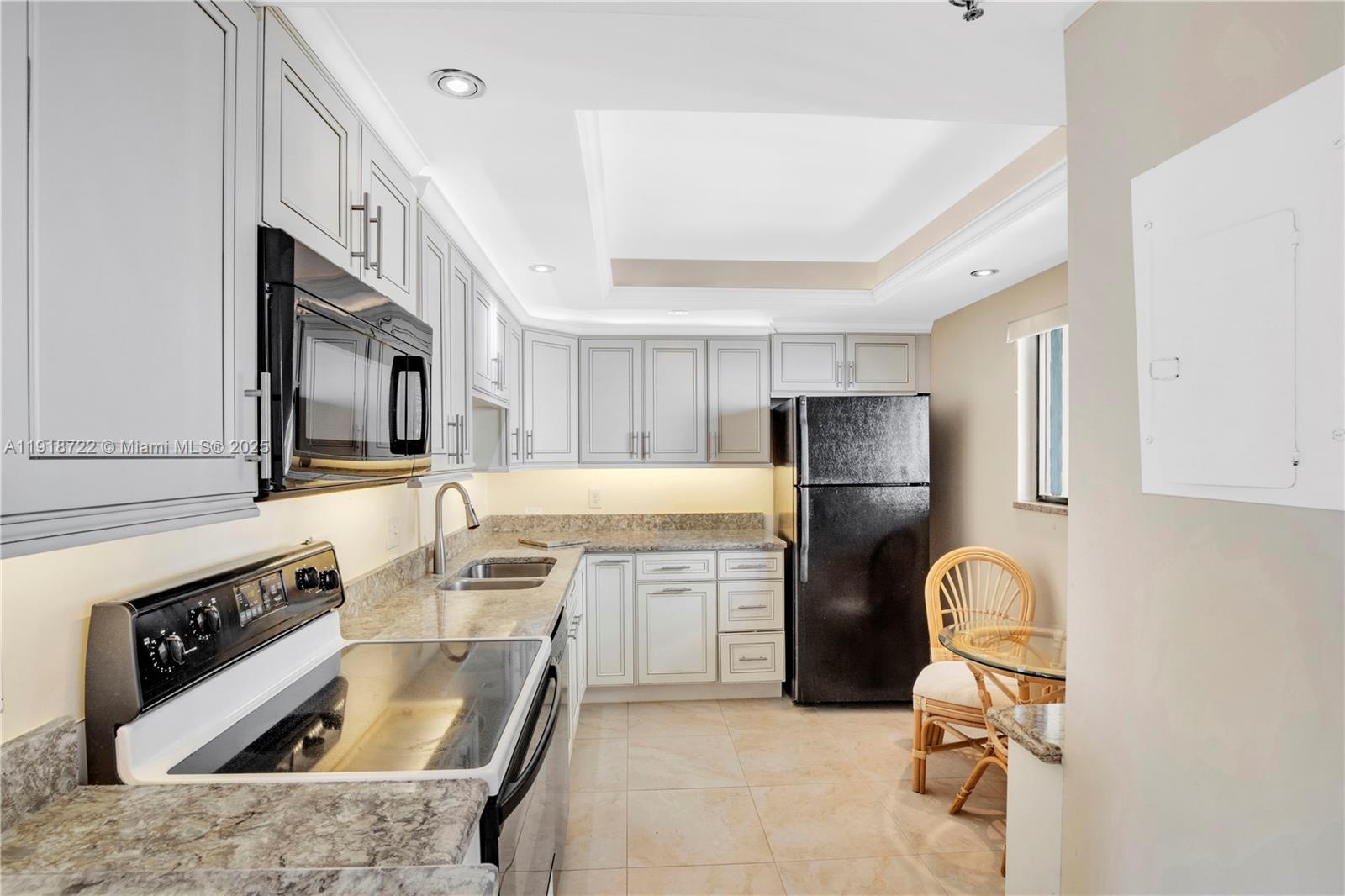 200 Ocean Trail Way, Unit 609 Jupiter, FL 33477 - Photo 9 of 27 a kitchen with stainless steel appliances granite countertop a sink stove and refrigerator