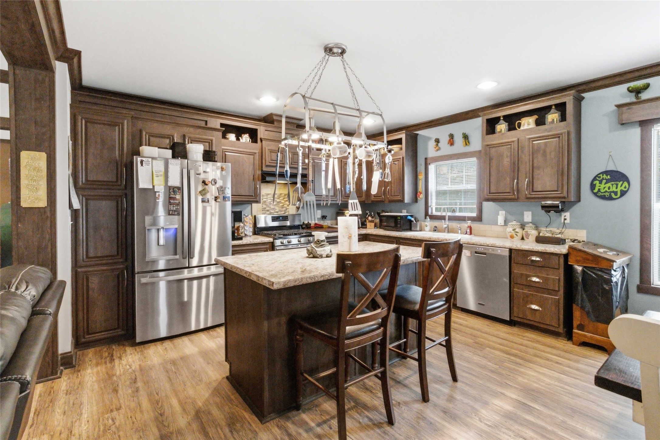 7921 Vista Ranch Road Smithville, TX 78957 - Photo 10 of 39 A functional kitchen boasts dark wood cabinetry and modern stainless-steel appliances.