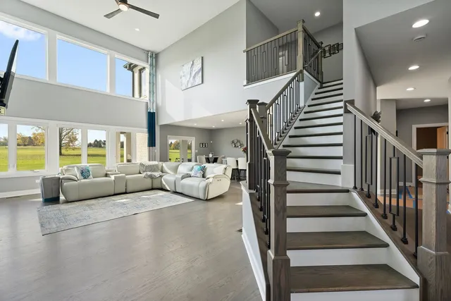 a living room with furniture and a chandelier