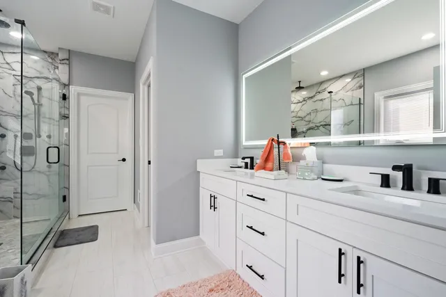 a bathroom with a sink double vanity and shower