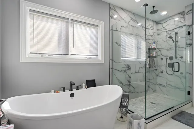 a bathroom with a tub and a shower