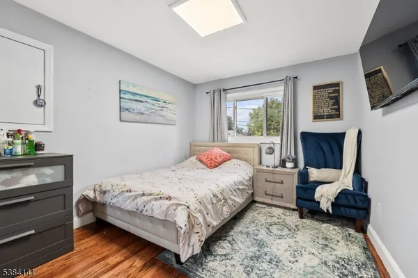 a bedroom with a bed chair and a fireplace