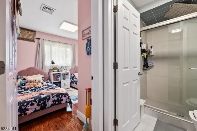 a bedroom with a bed and a mirror