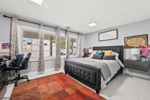a bedroom with a bed and a large window