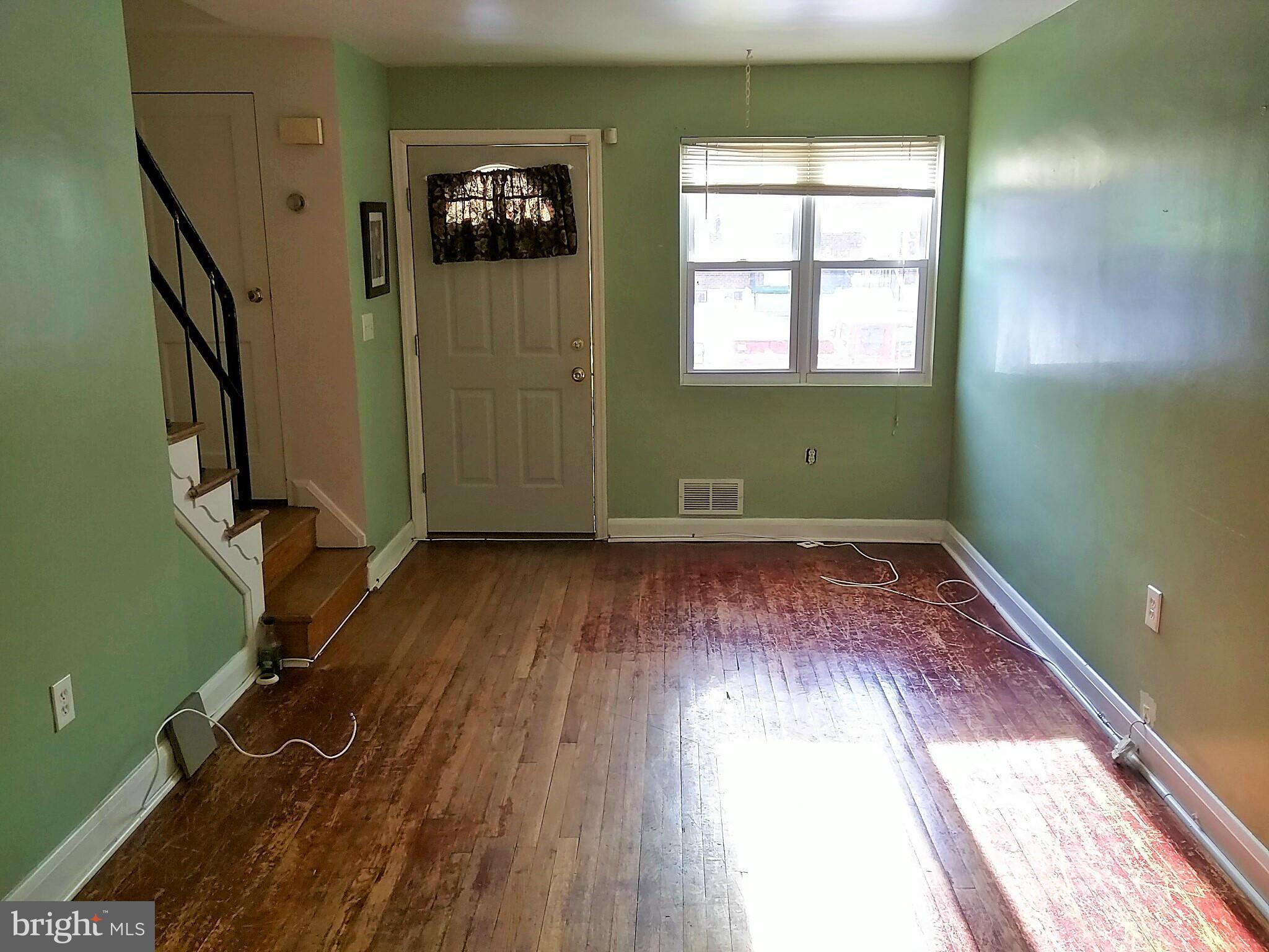 6939 Glenheights Road Baltimore, MD 21215 - Photo 2 of 21 a view of empty room with wooden floor and fan