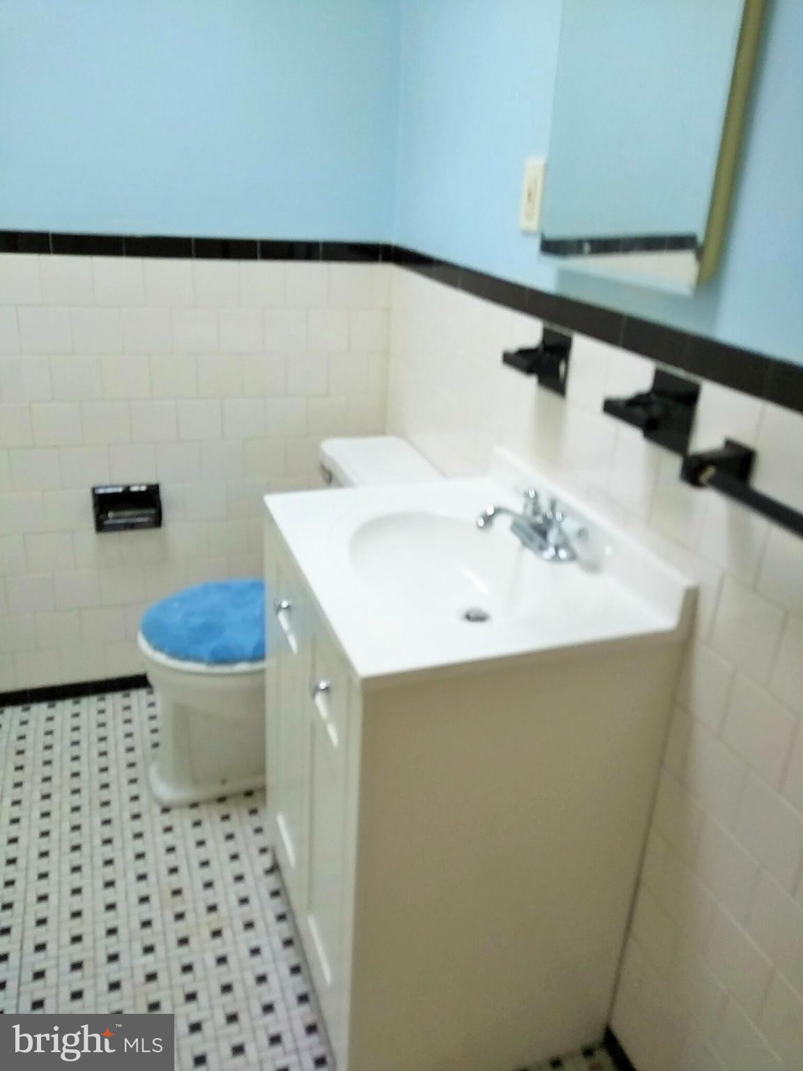 6939 Glenheights Road Baltimore, MD 21215 - Photo 13 of 21 a bathroom with a sink and a toilet