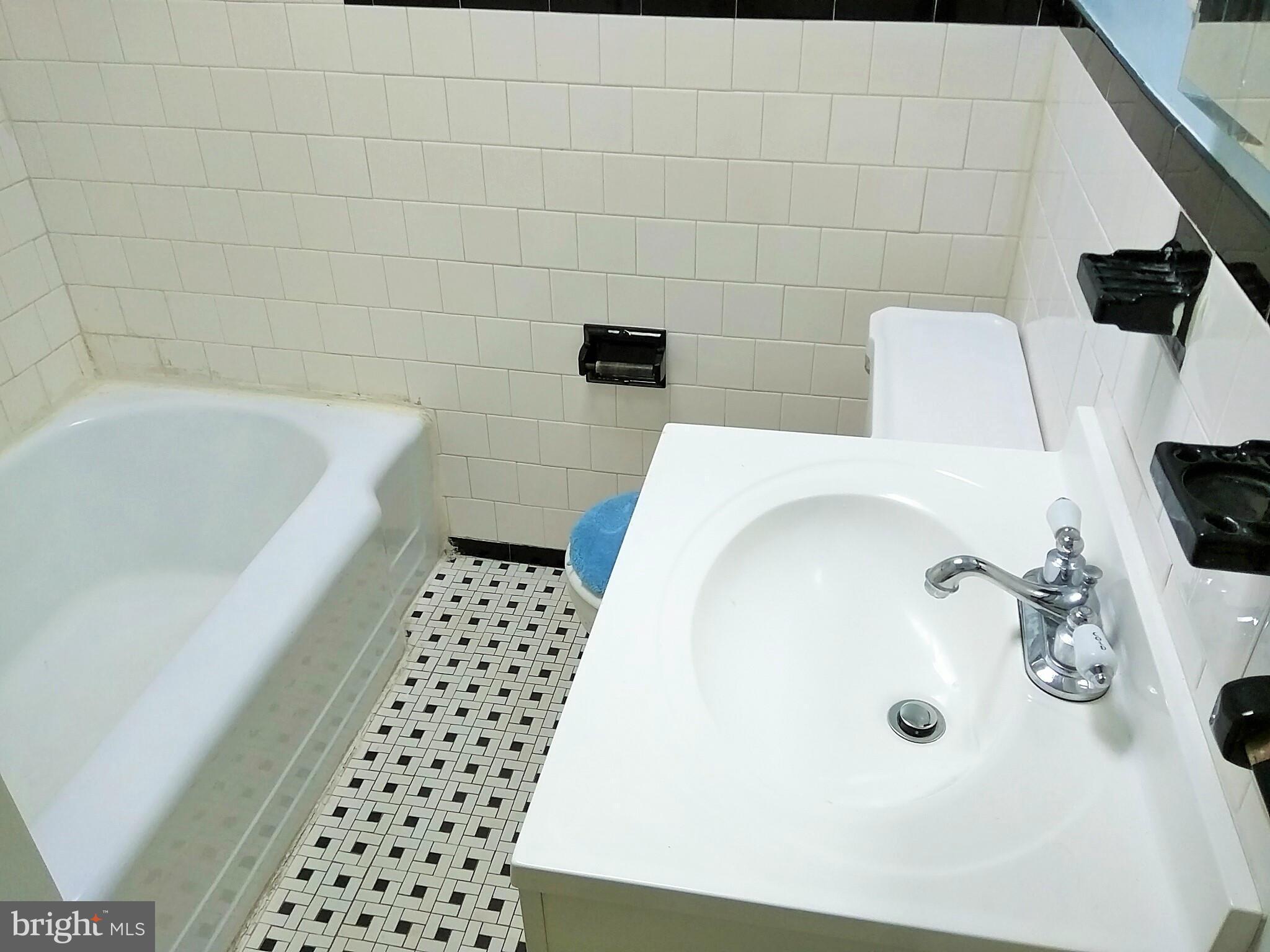 6939 Glenheights Road Baltimore, MD 21215 - Photo 14 of 21 a bathroom with a bathtub