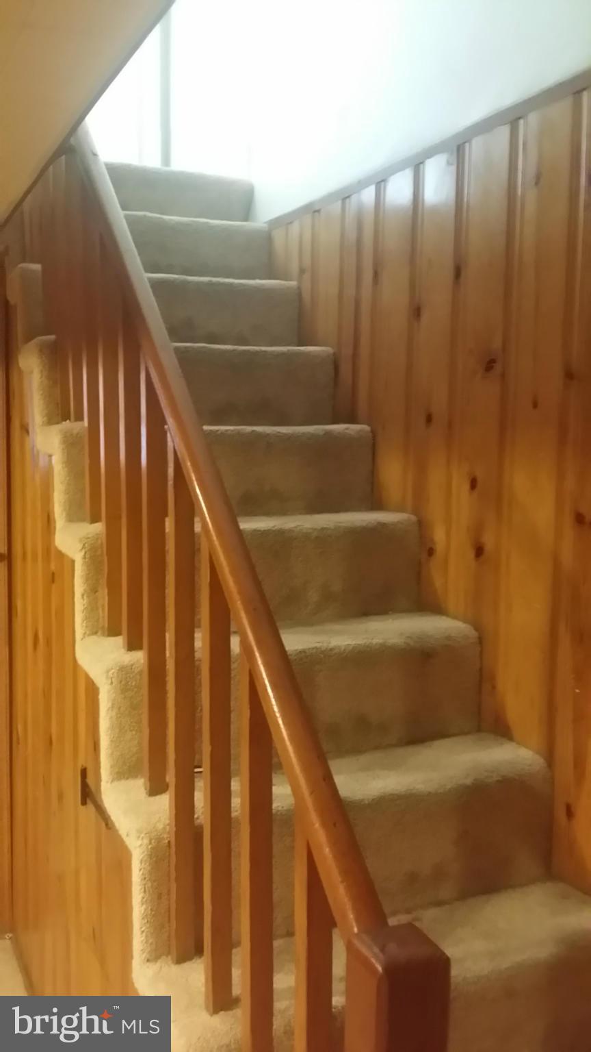 6939 Glenheights Road Baltimore, MD 21215 - Photo 18 of 21 a view of staircase with railing and a window