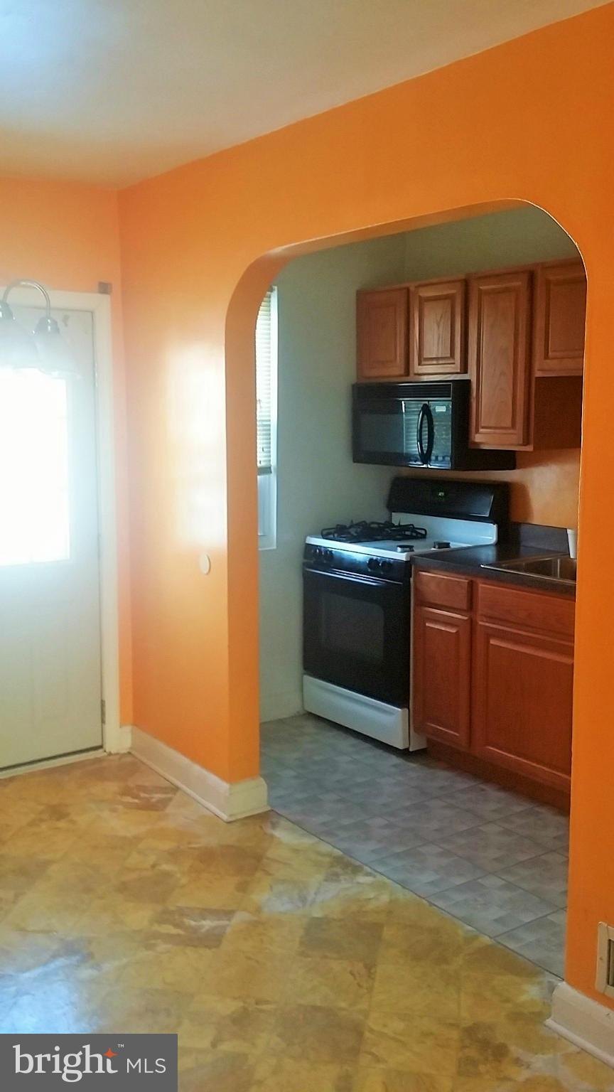 6939 Glenheights Road Baltimore, MD 21215 - Photo 6 of 21 a kitchen with stainless steel appliances granite countertop a sink and cabinets