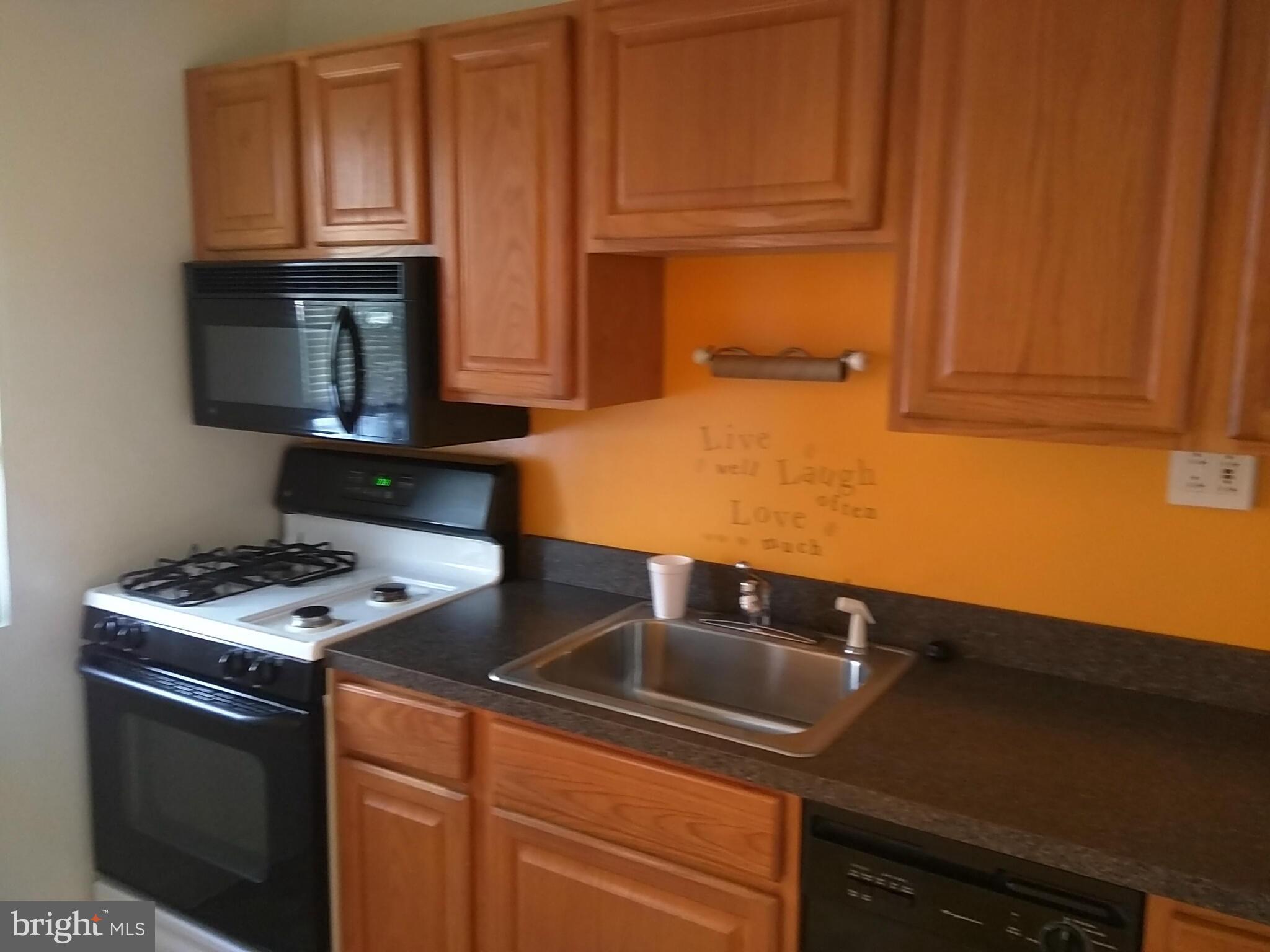 6939 Glenheights Road Baltimore, MD 21215 - Photo 7 of 21 a kitchen with granite countertop a stove and a sink