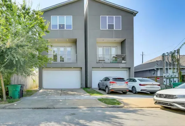 a couple of cars parked in front of a house