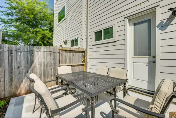 a view of backyard with a chair and table