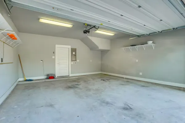 a roof deck with a couch and potted plants