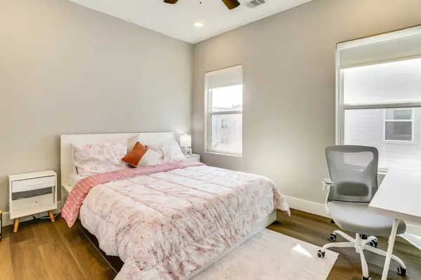 a en suite bathroom with a double vanity sink a toilet and a mirror