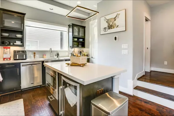a kitchen with stainless steel appliances cabinets and a window
