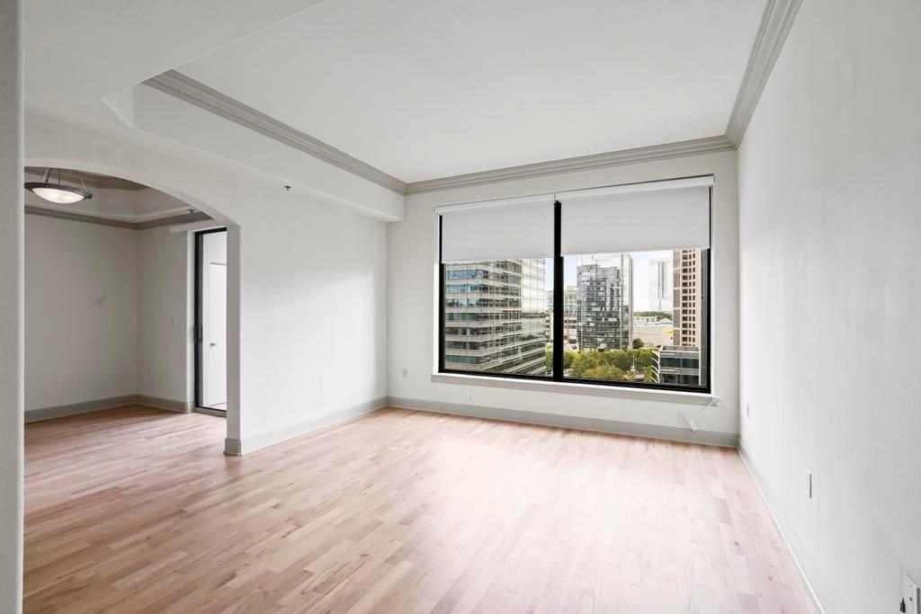 3445 Stratford Road Northeast, Unit 1604 Atlanta, GA 30326 - Photo 1 of 1 a view of an empty room with wooden floor and a window